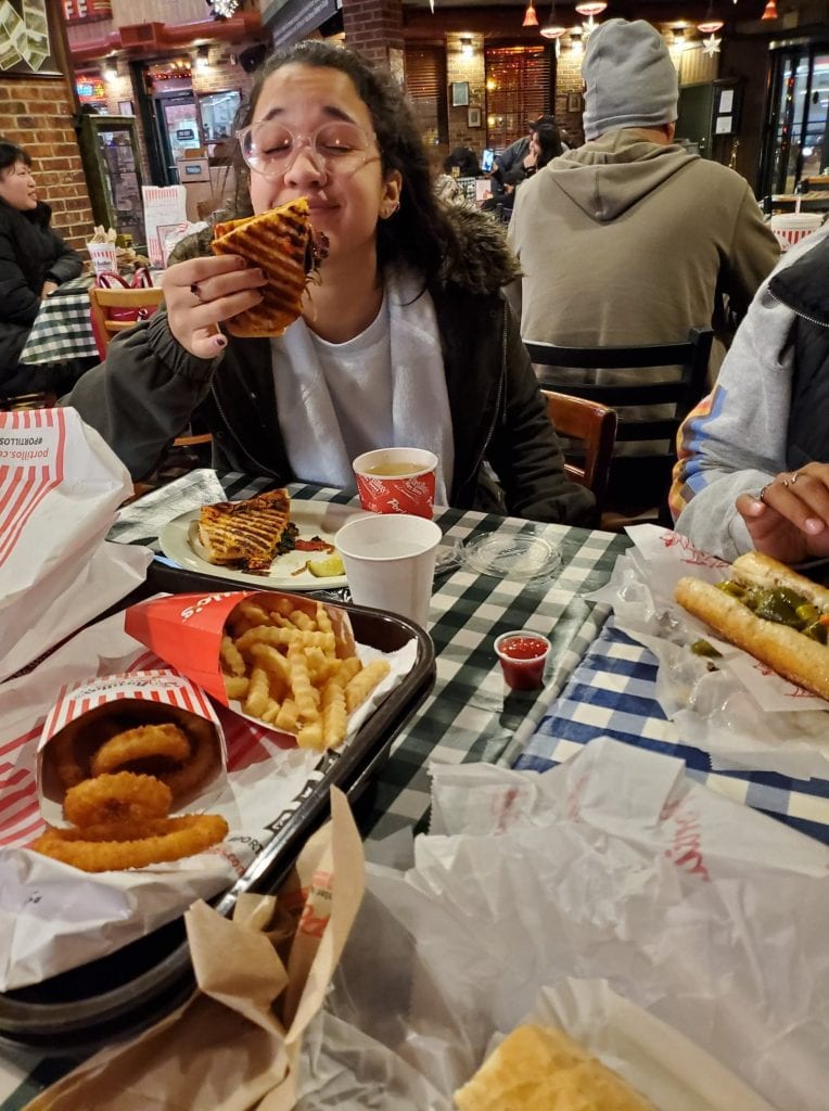 Eating a chicago dog inside Portillo's in Chicago